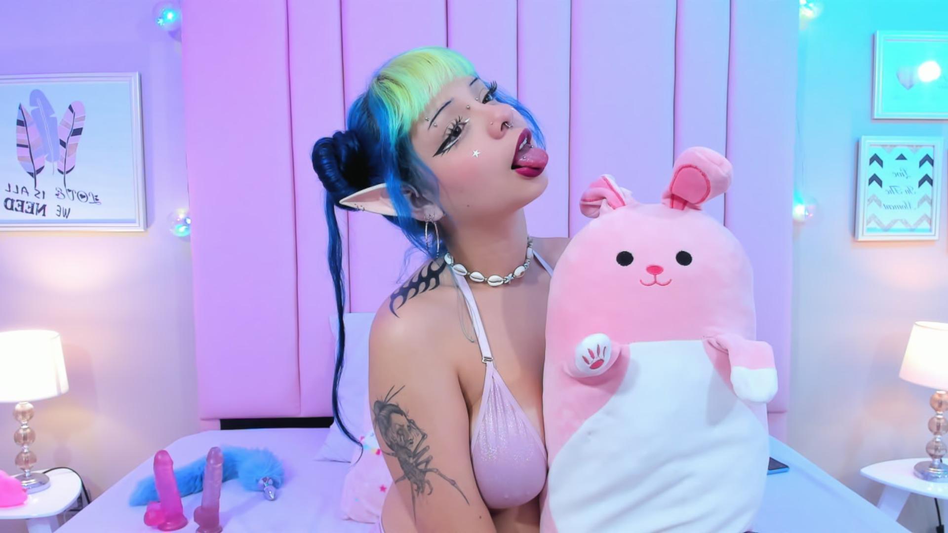 Young cosplay girl with tattoos and elf ears loves to stream for her fans and gets naked for them delighting her audience with her sexy boobs and big teen ass ready to get pounded and cummed on with intense Lush vibes. She pulls out her tongue letting her hot saliva drool on her neck and saggy boobs